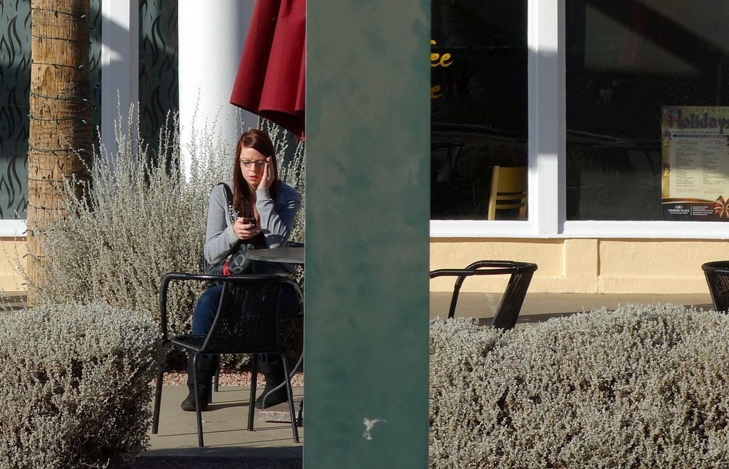 Teenage Girl Sitting At Table Outside - Teen Rehab