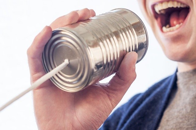 Teenager Talking Through Tin Can Phone - Teen Rehab