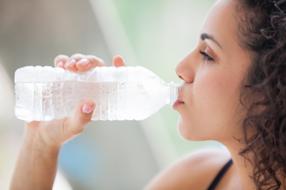 Teen girl drinking water