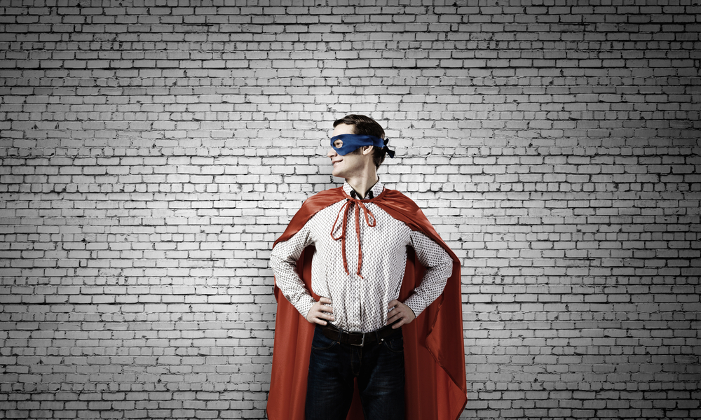 young man boy mask cape superhero brick wall