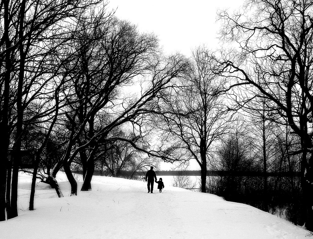 black white photograph parent child park nature snow winter