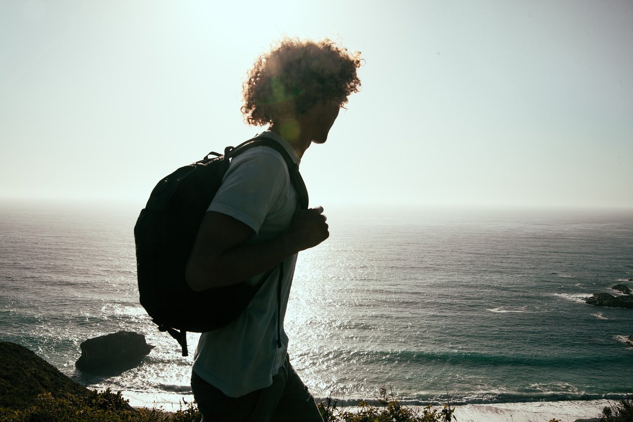 young-man-hiking-by-ocean