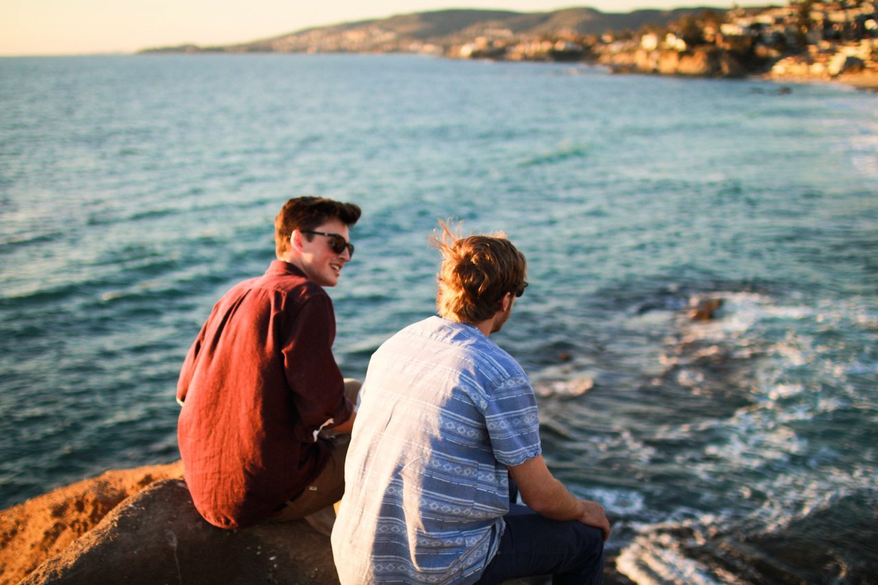 guys-sitting-by-ocean-talking