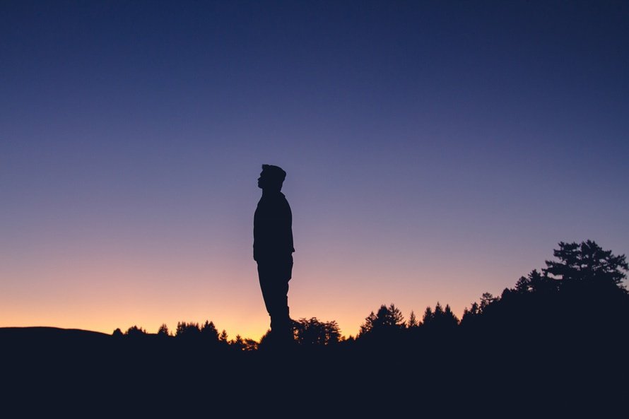Person silhouetted against sunset