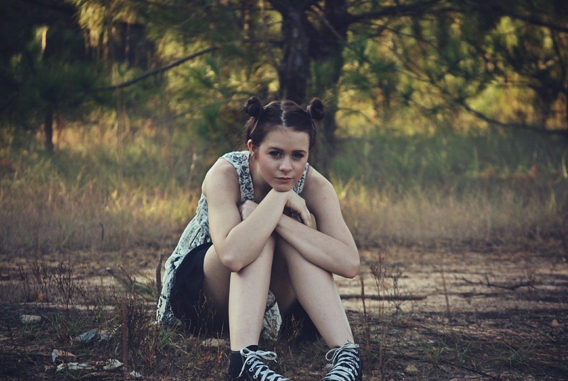teen girl outdoors woods sitting