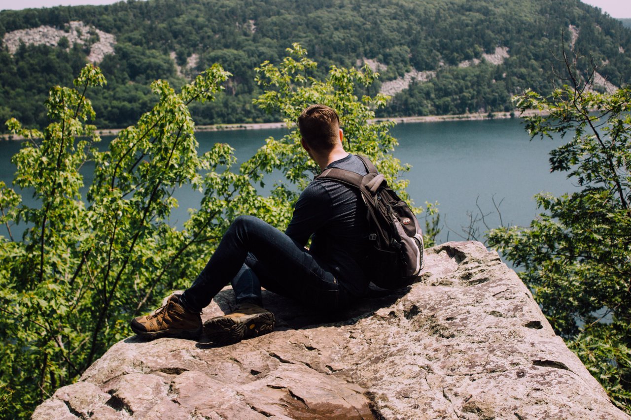 calm teen sitting on rock