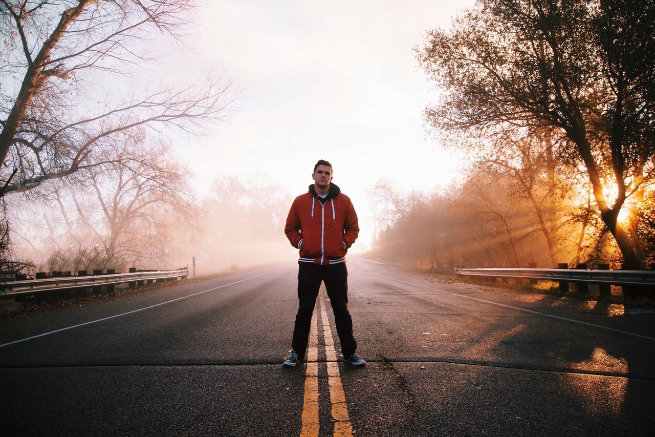teen standing in middle of road