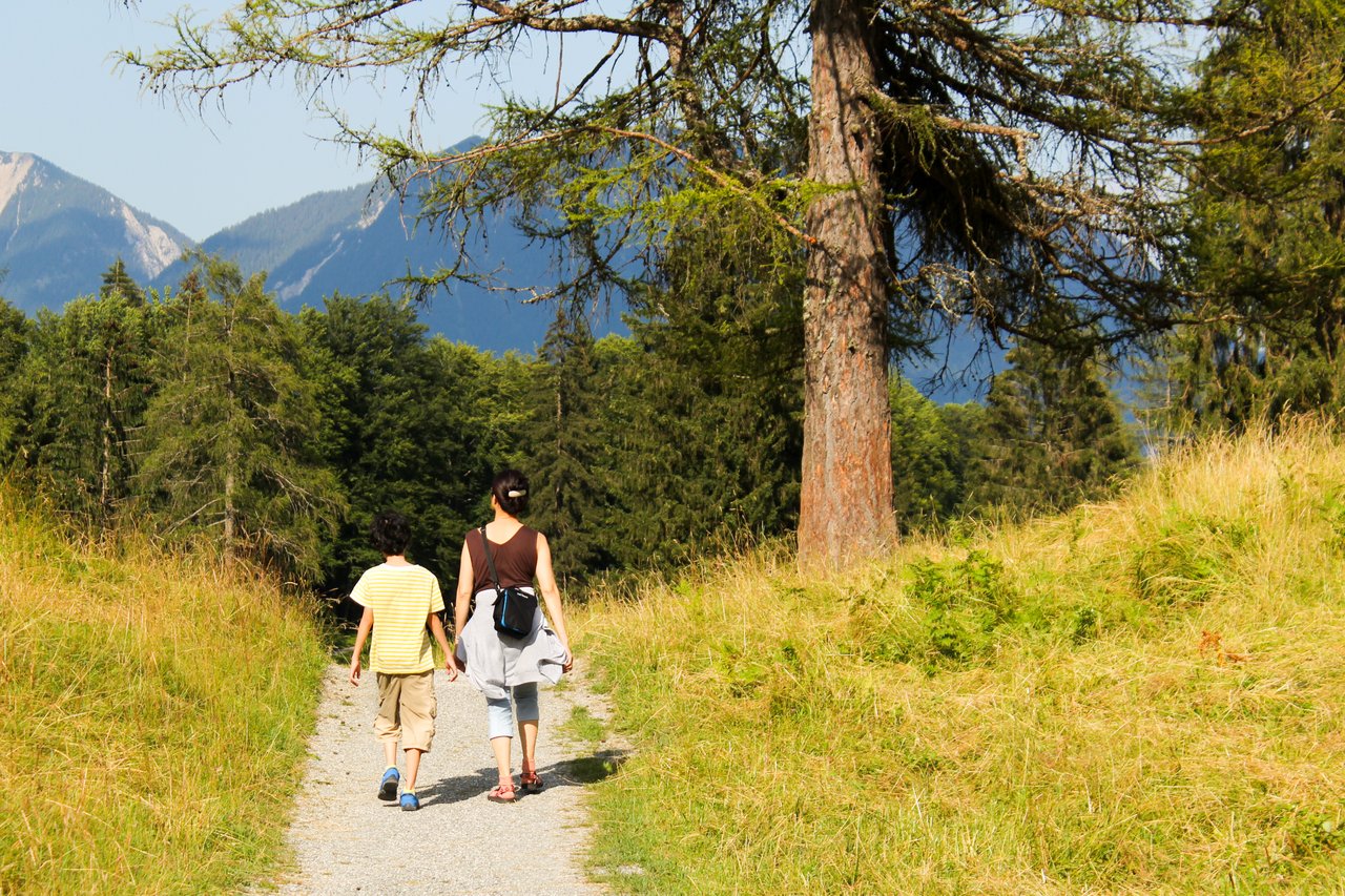 mother and child walking along a trail