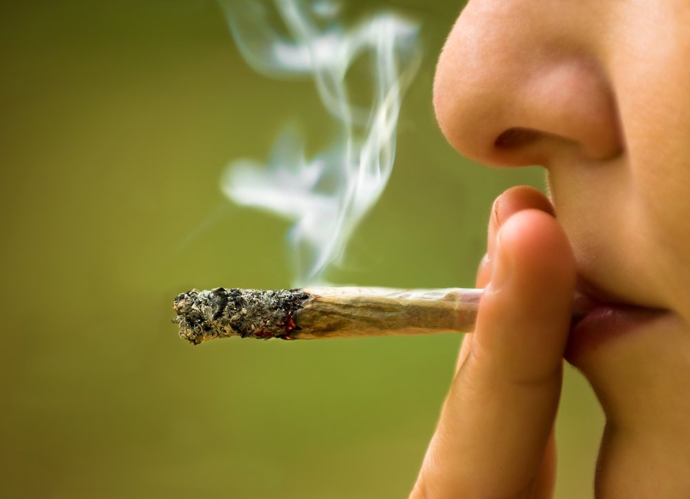 Teen smoking marijuana joint