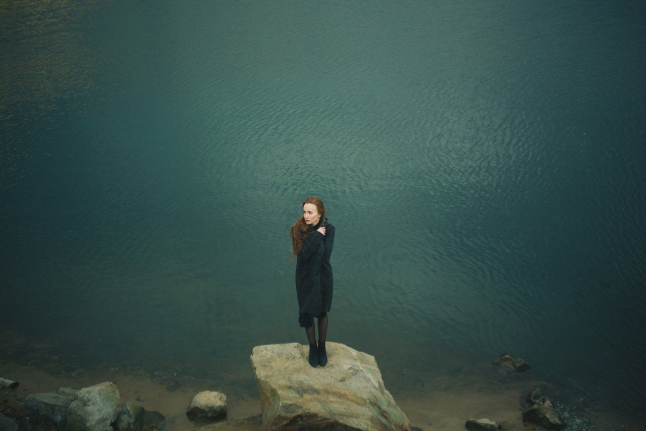 girl-standing-alone-on-rock