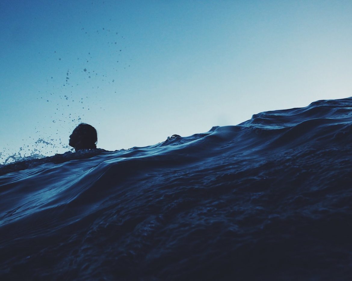 teens swimming ocean water