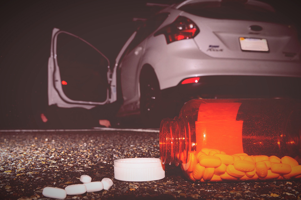 pills on ground near car